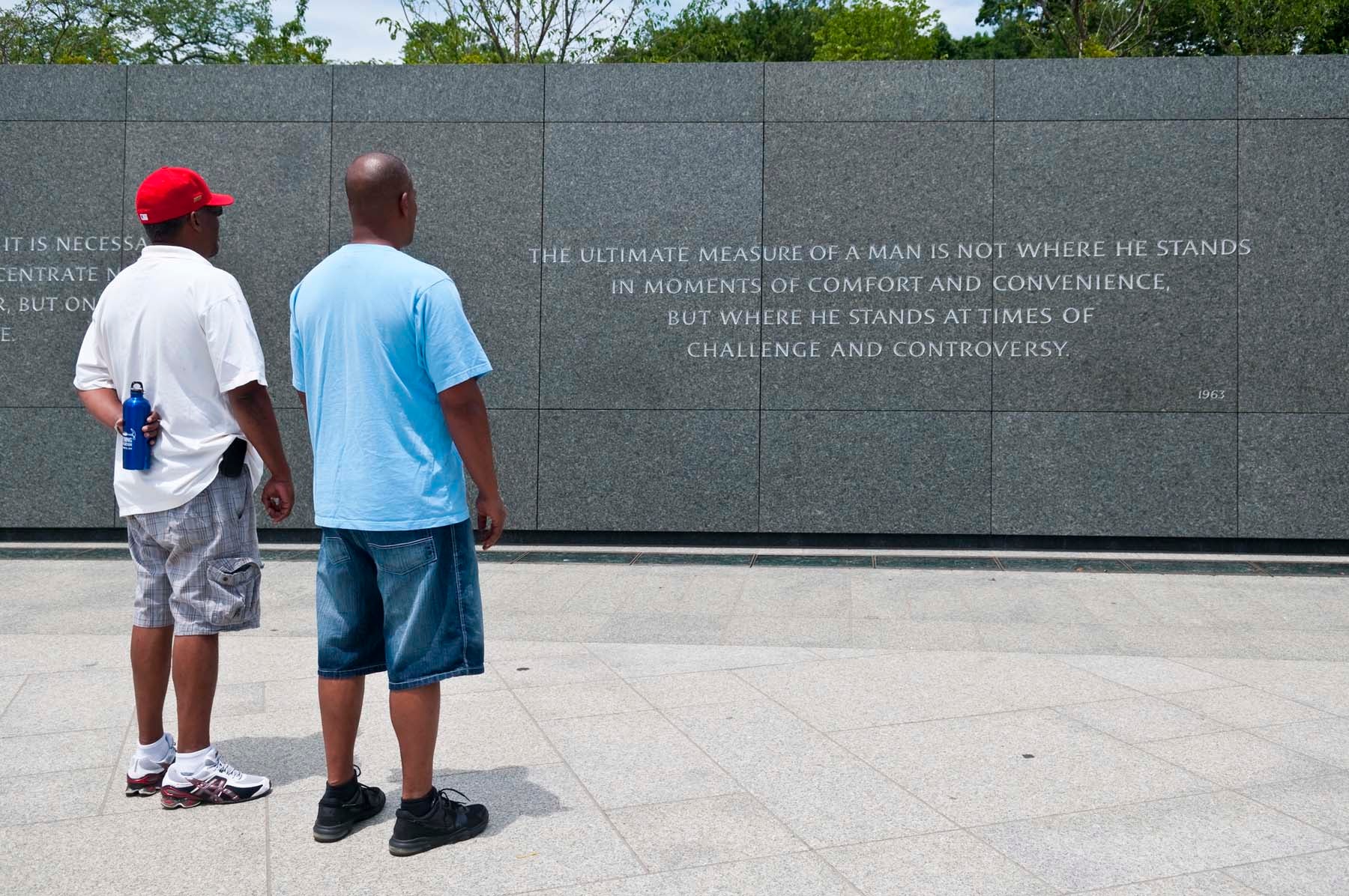 Two African-American men stand together at the Martin Luther King Jr Memorial in Washington DC